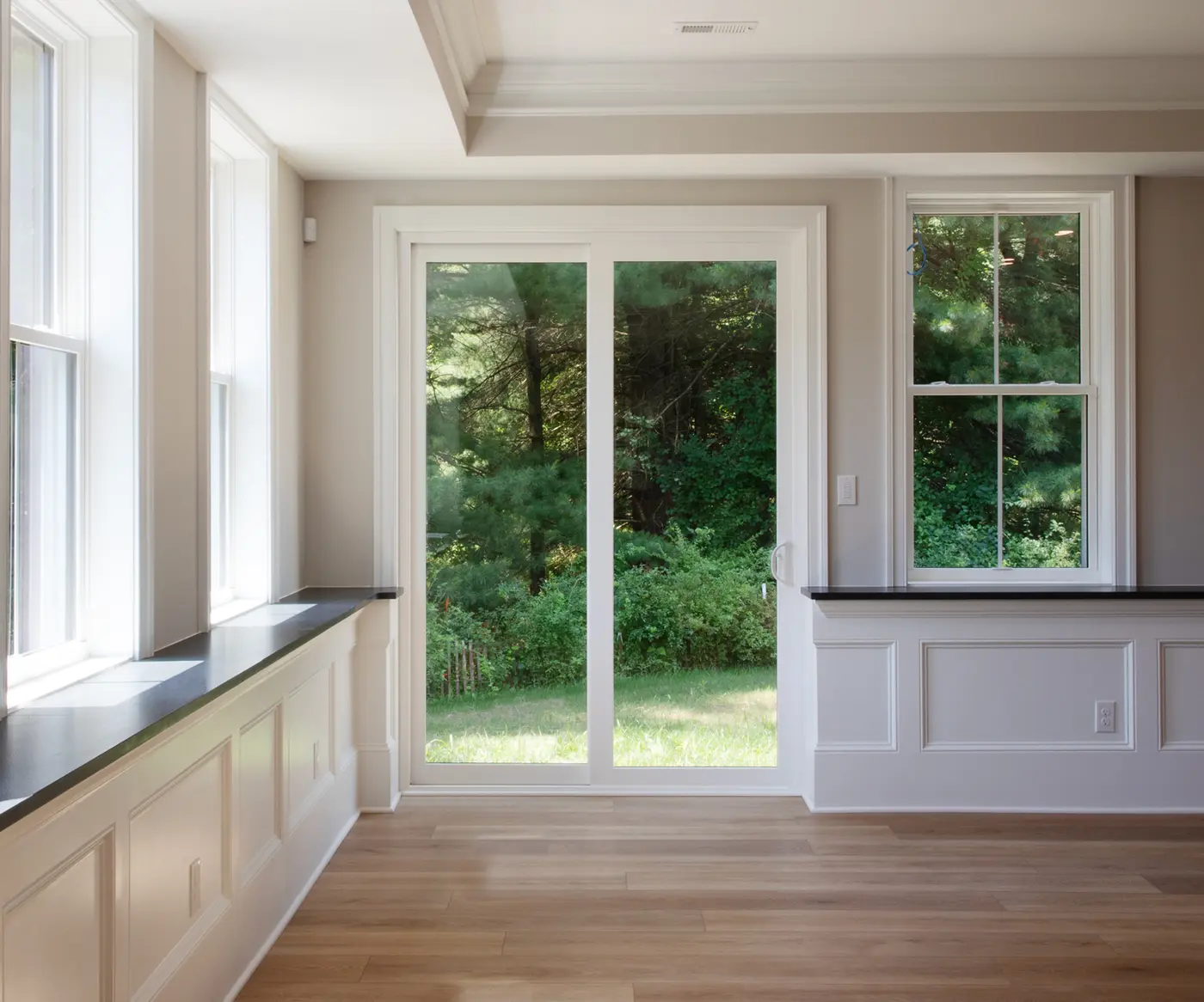 White OKNA Elegante sliding patio door in a bright living space